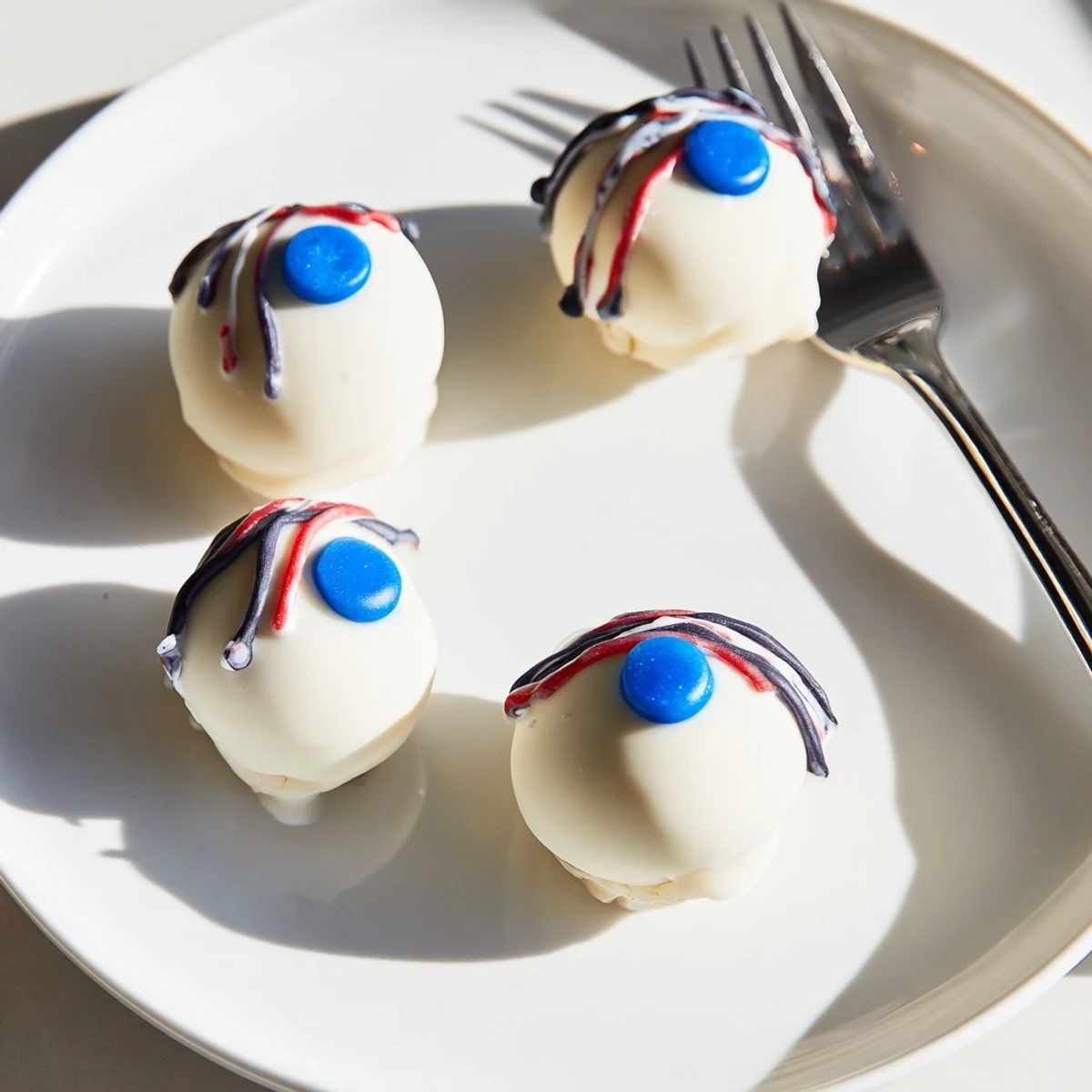 Chilled Halloween Cake Eyeballs arranged on a dark serving board for a haunting party display