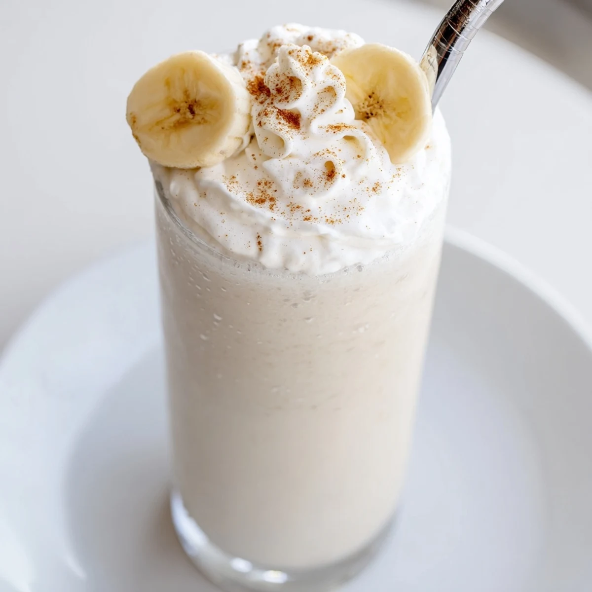 Refreshing Vanilla Banana Shake served for breakfast, topped with sliced banana