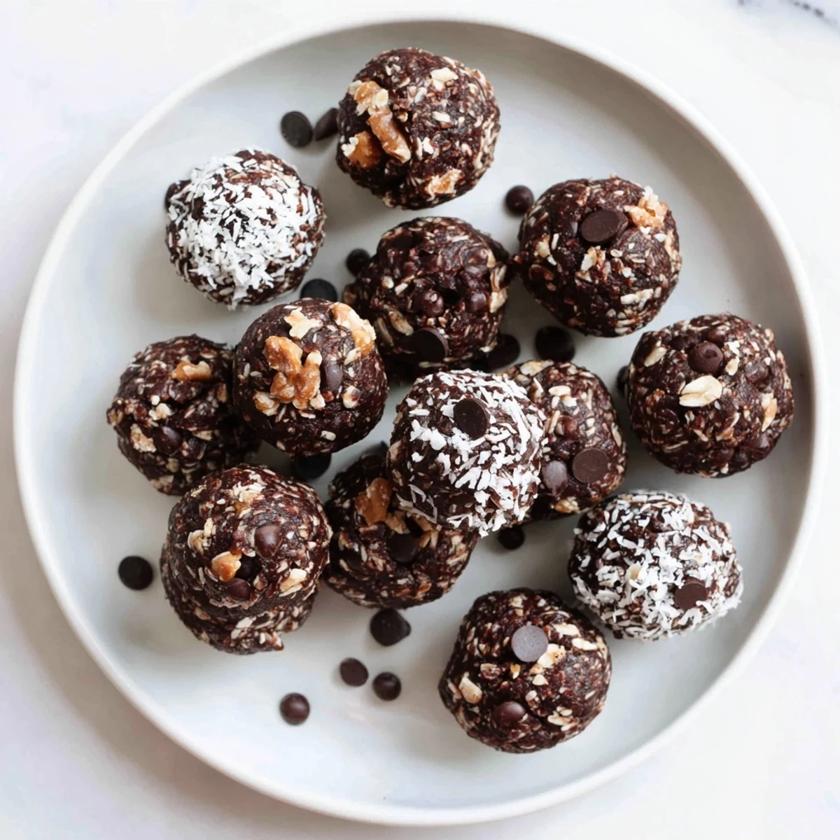 Dark chocolate no bake brownie bites arranged on a white serving platter