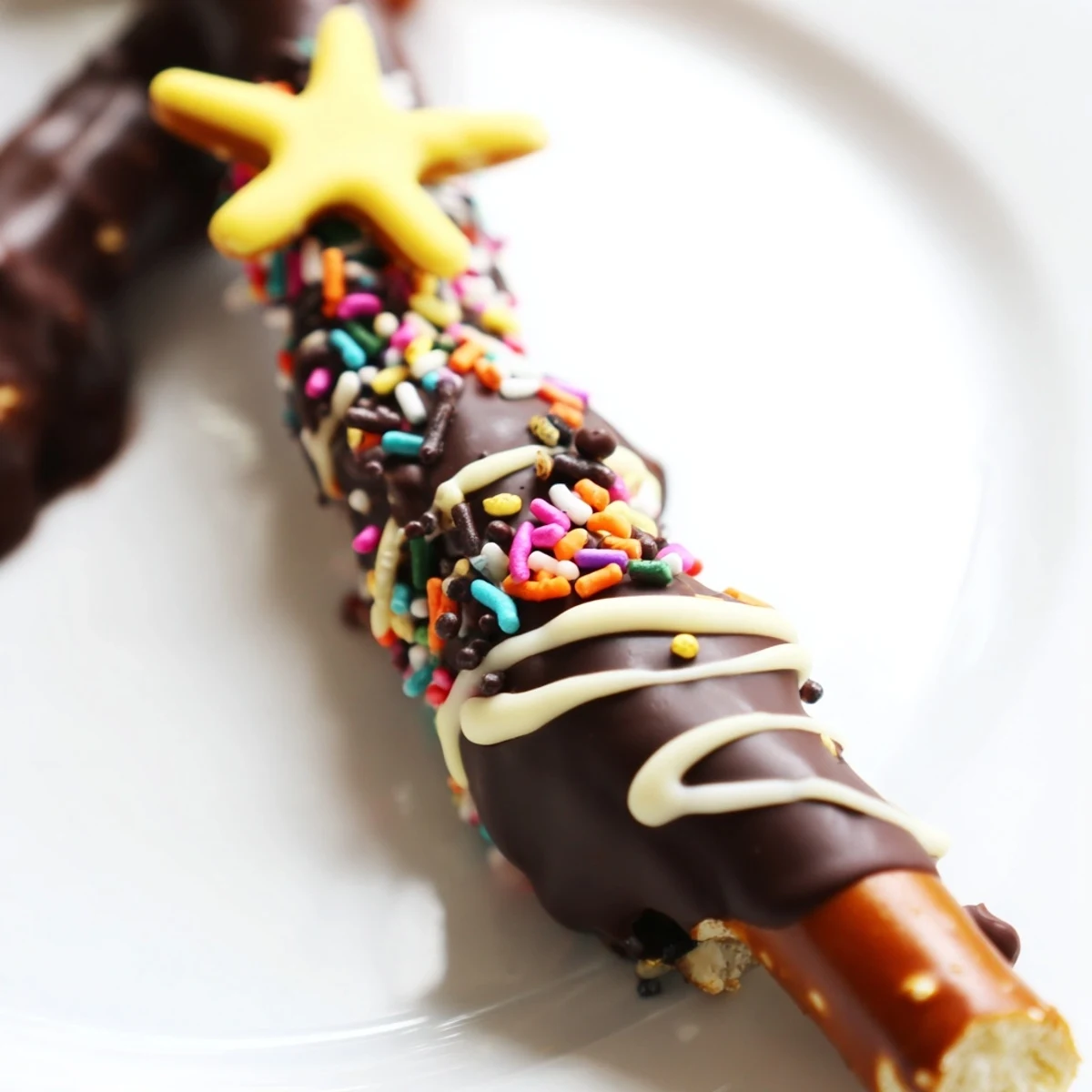 Whimsical Christmas tree pretzels coated in creamy chocolate with assorted sprinkles and mini pearl decorations