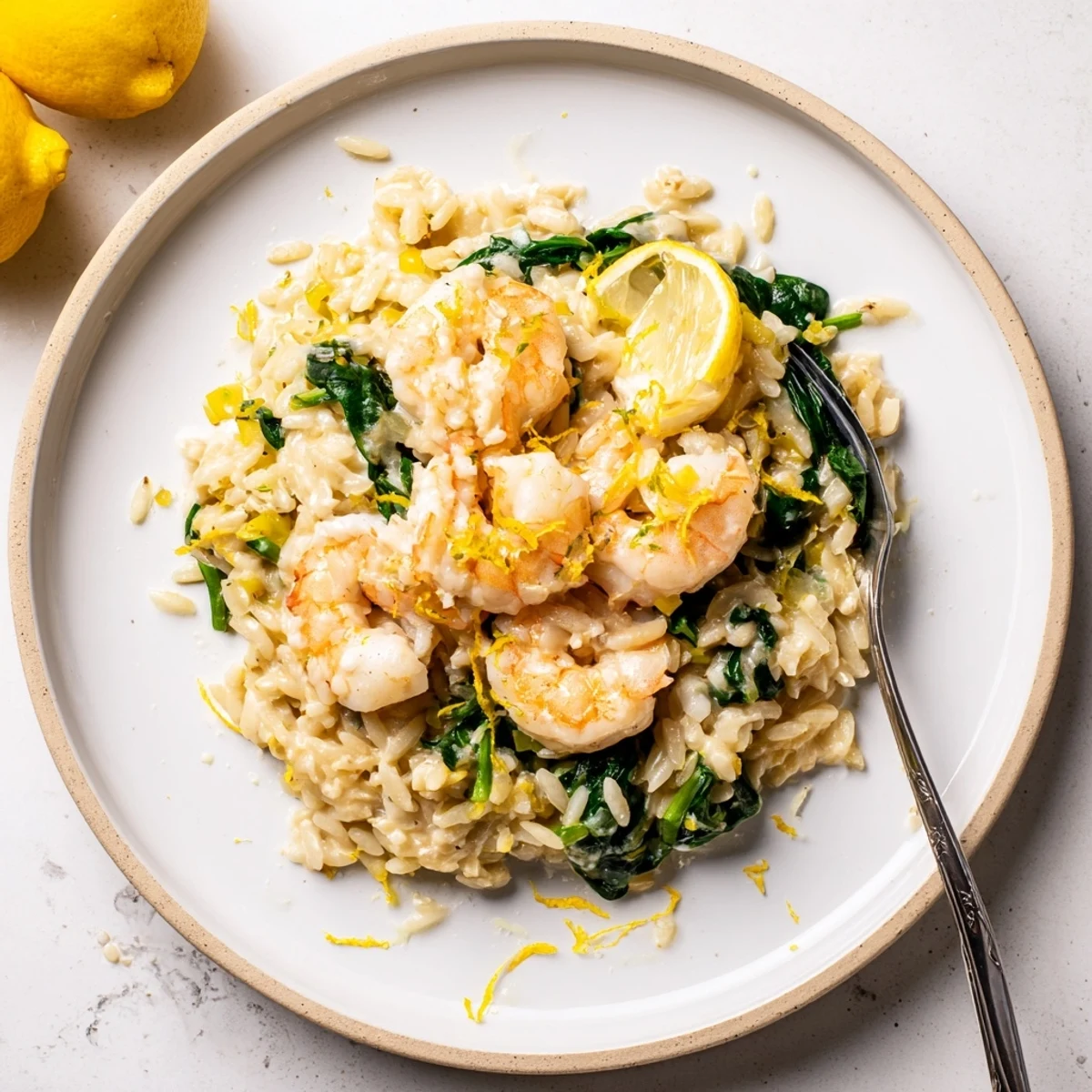 Creamy Shrimp Orzo Recipe in a shallow bowl, steam rising, lemon garnish