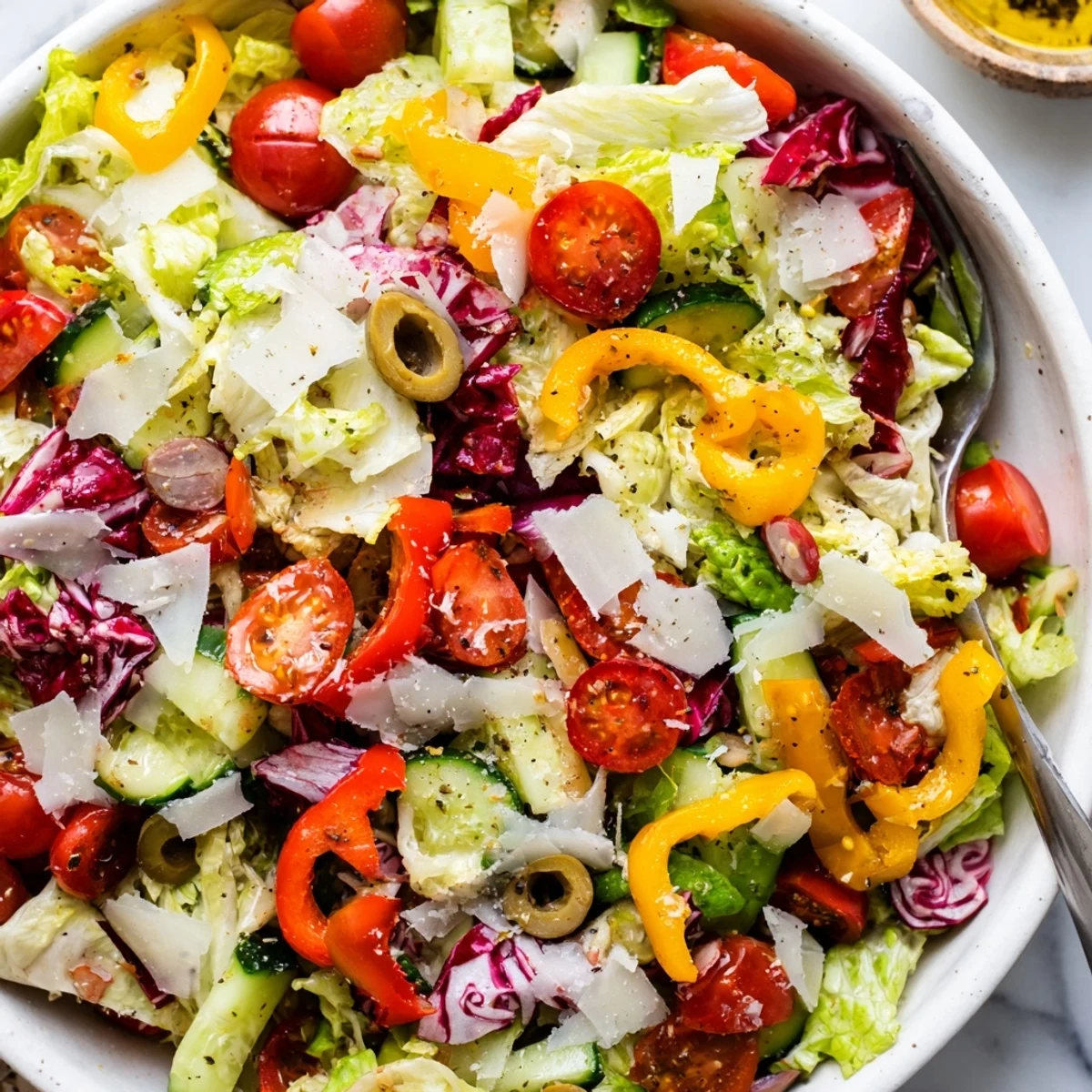 Zesty Italian Chopped Salad With Parmesan And Peppers piled high, crunchy, tangy dressing.