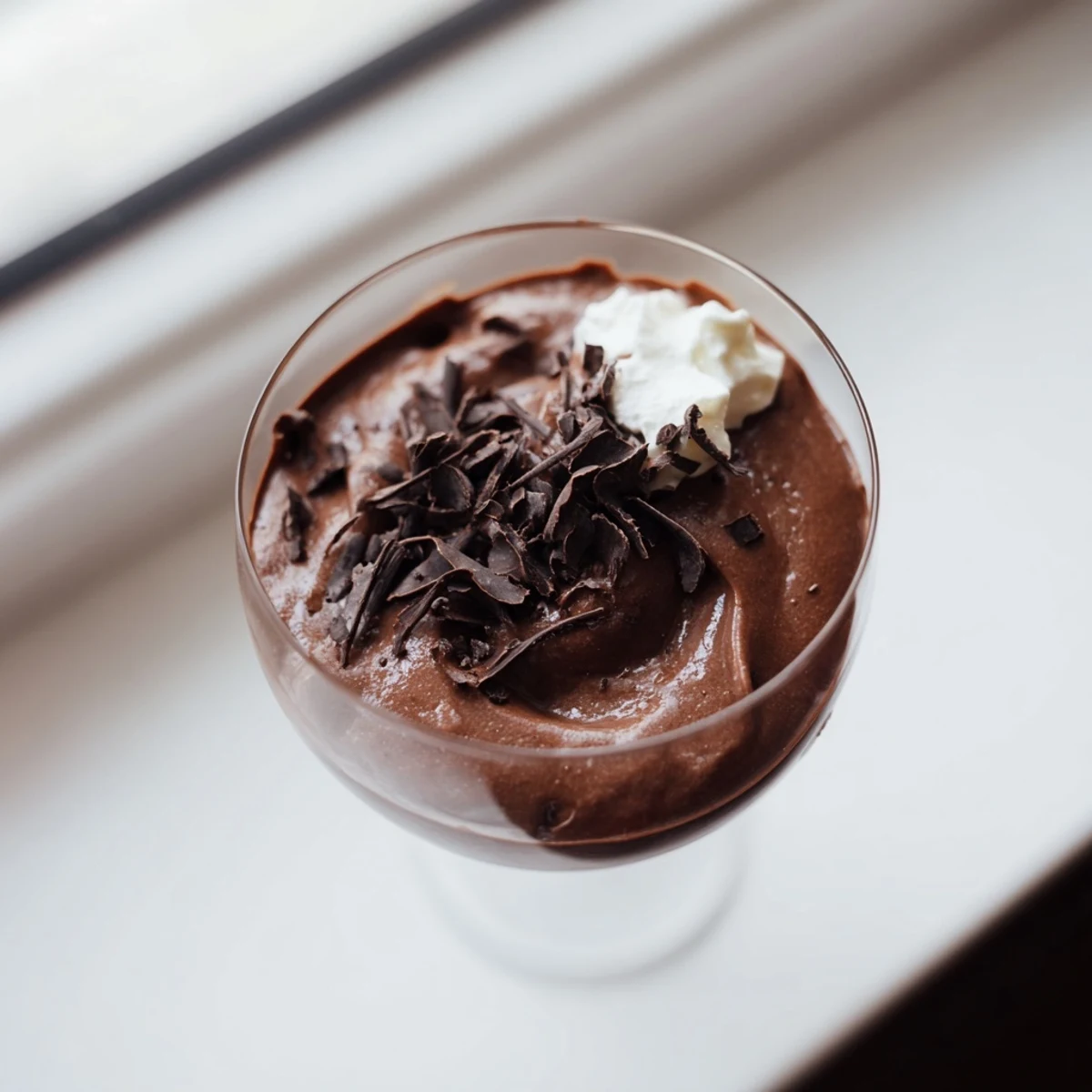 Velvety chocolate mousse served in elegant glasses topped with chocolate shavings