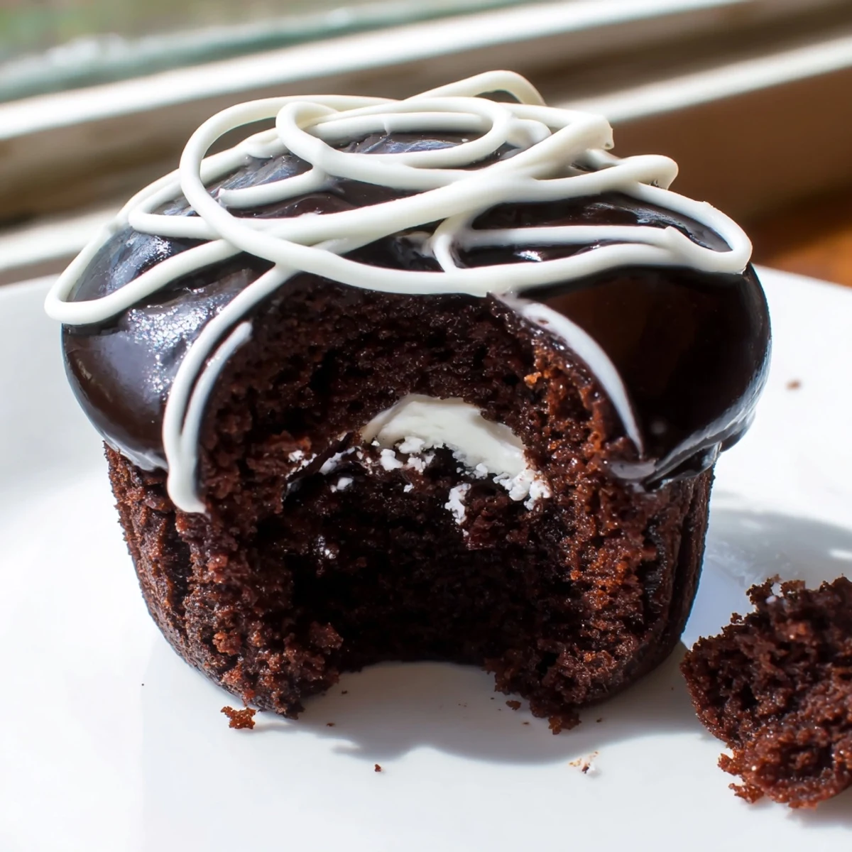 Homemade Hostess Cupcakes with glossy ganache topping and fluffy marshmallow cream filling