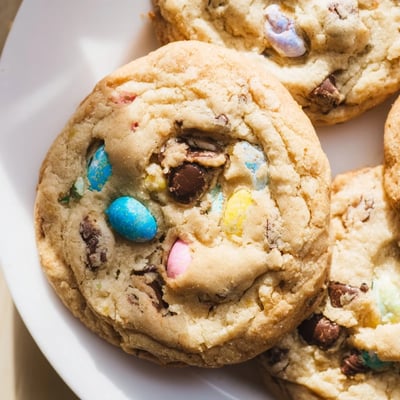Chewy Cadbury Egg Cookies topped with melted chocolate and pastel egg fragments close up