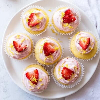 Light and fluffy lemon cupcakes crowned with creamy strawberry buttercream and sprinkled with bright lemon zest