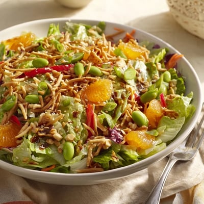 Colorful Mandarin Sesame Crunch Salad featuring juicy orange segments crisp peppers and a drizzle of sesame dressing